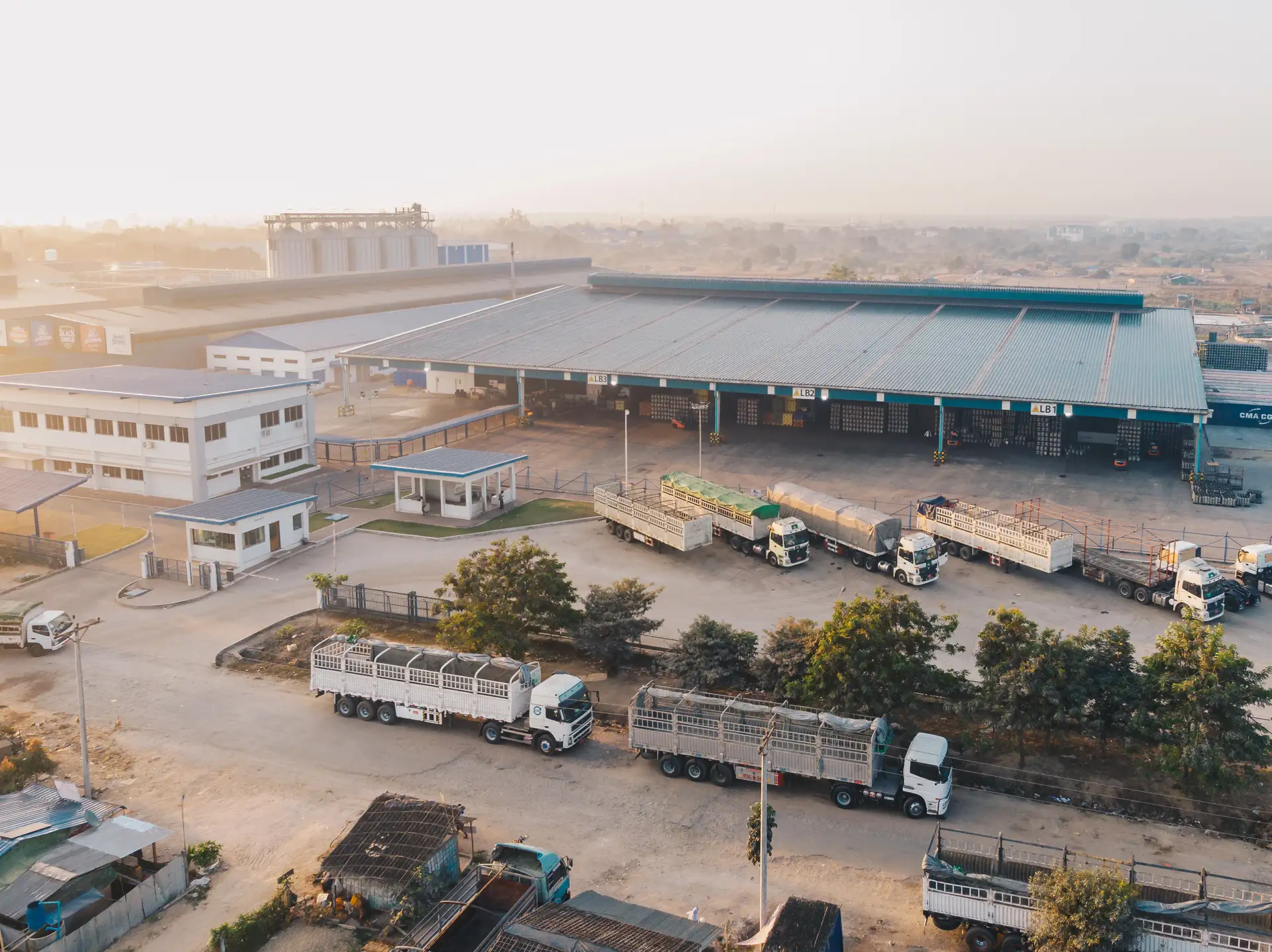 Yard with trucks and warehouse seen from above – CGM Trasporti